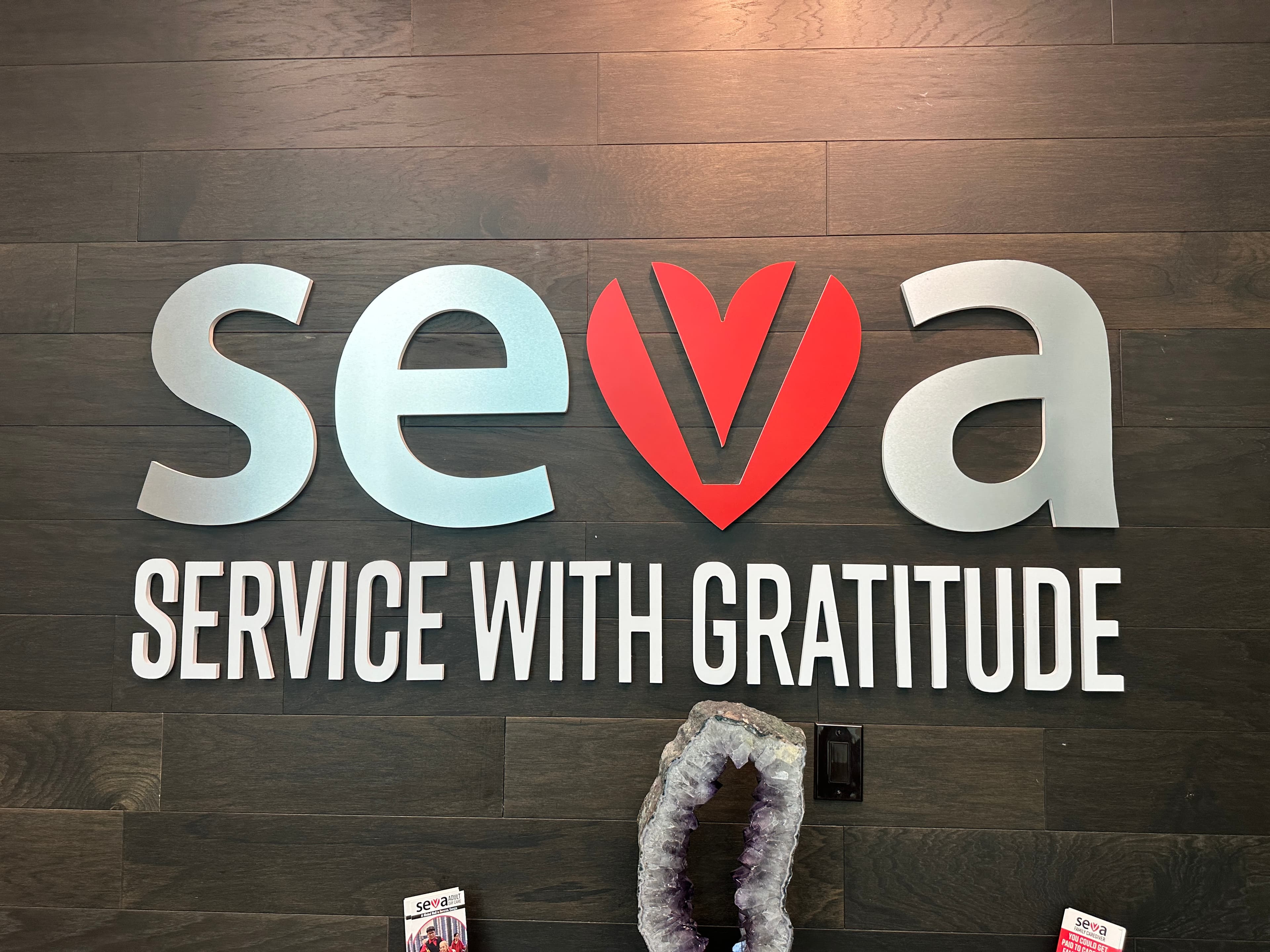 The Seva Service with Gratitude sign on the wood entrance wall