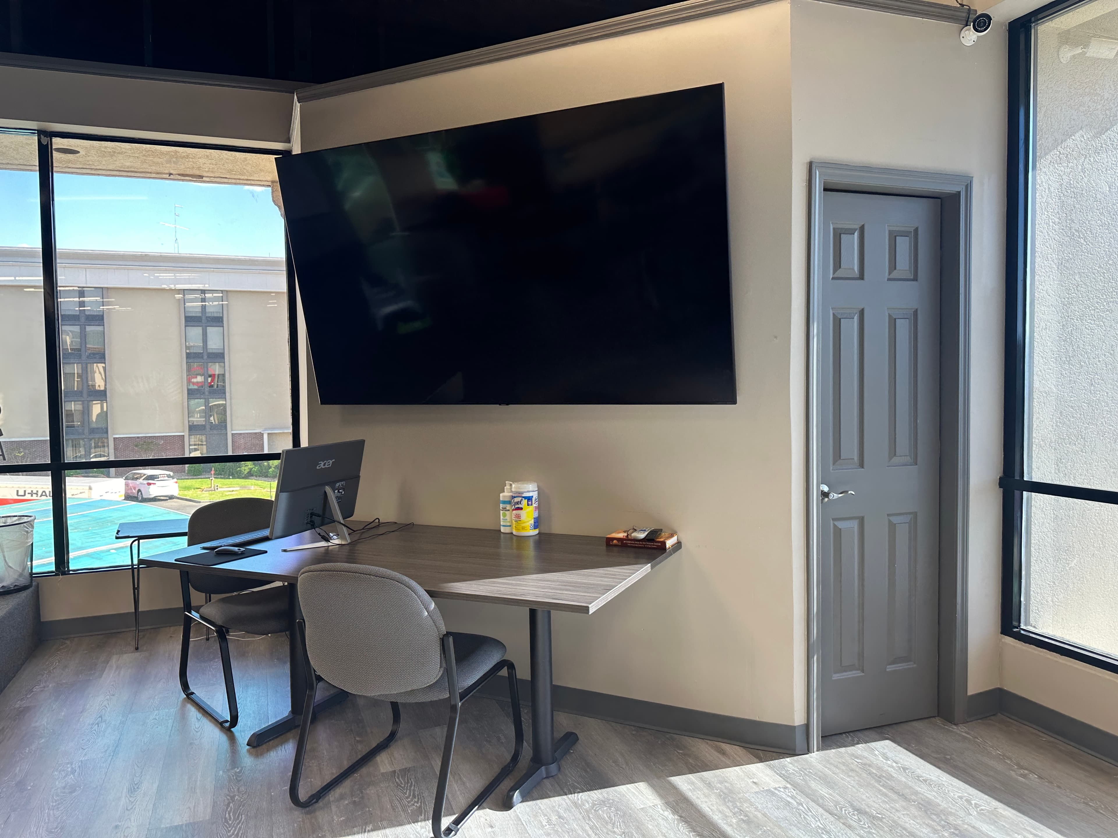 A dining and meeting area with a wall-mounted television