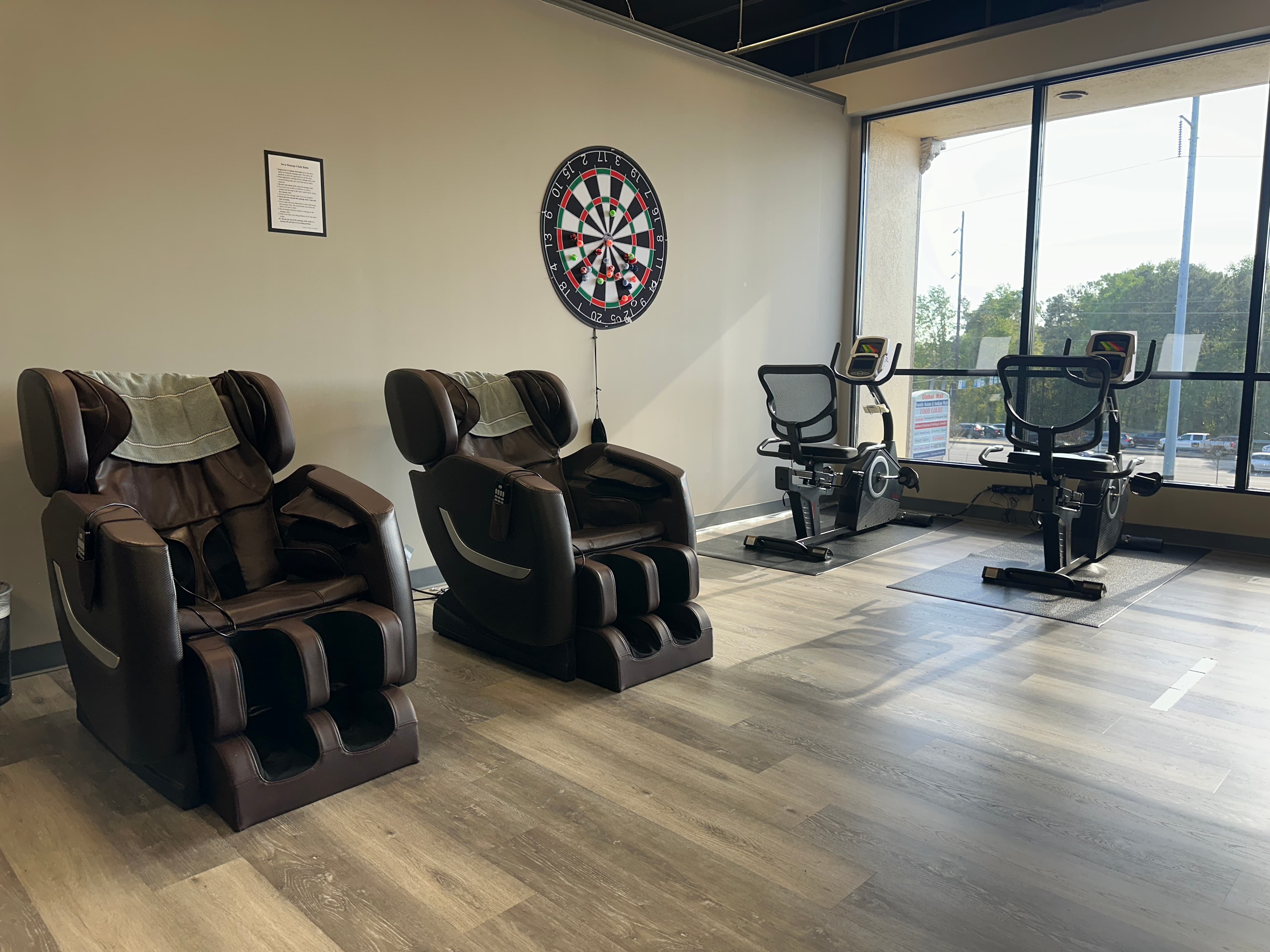 Reclining massage chairs and exercise equipment along the window
