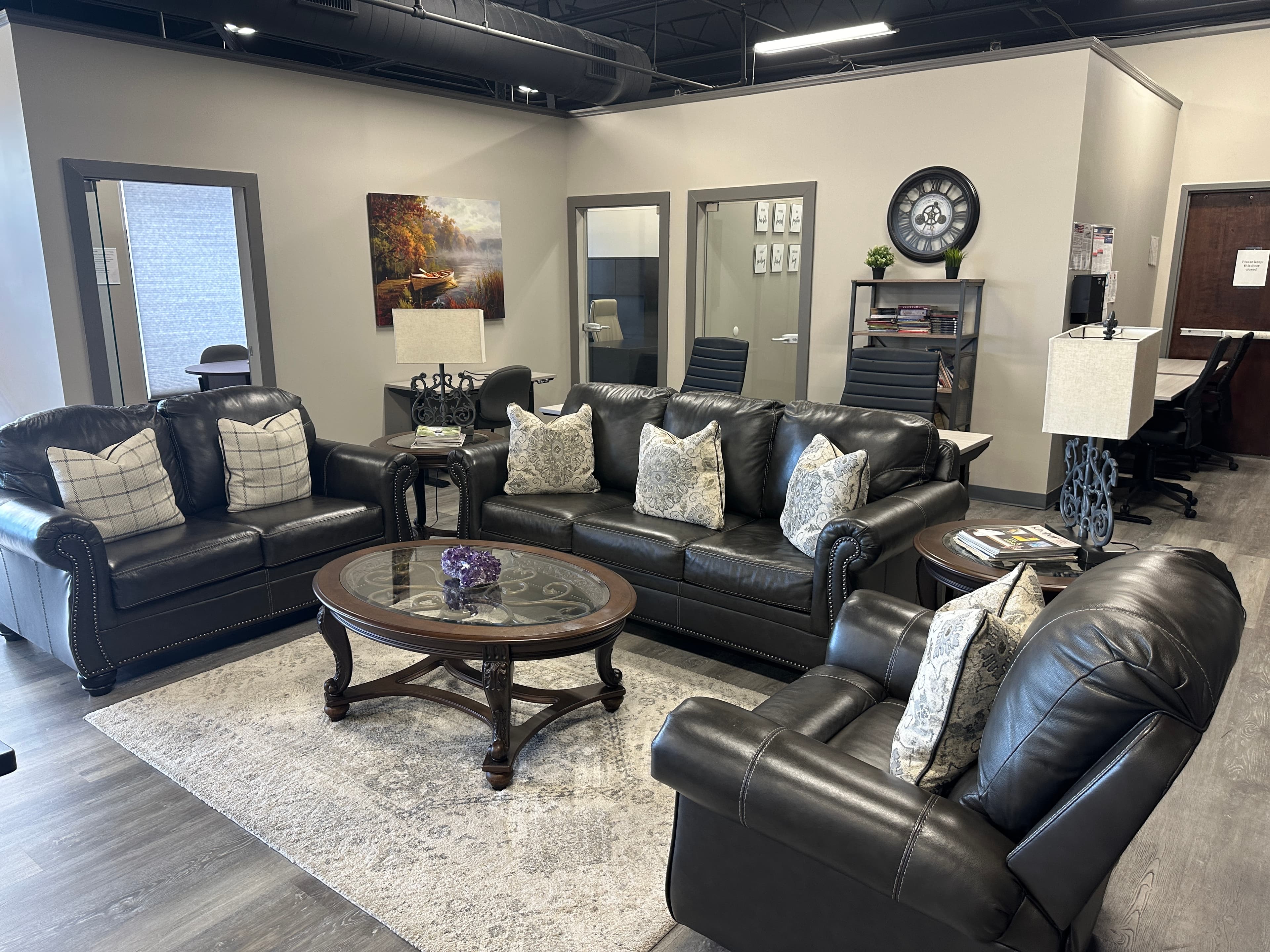 A living room area with leather sofas around a glass coffee table